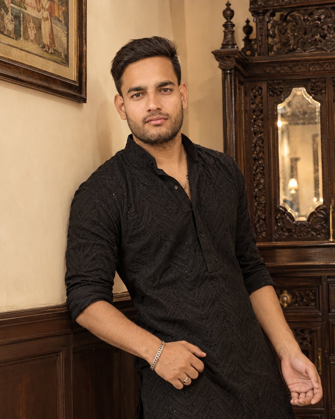 Young man stand in kurta in VIP room front of the mirror.